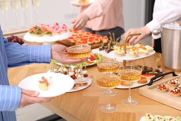 People with different appetizers at buffet, closeup