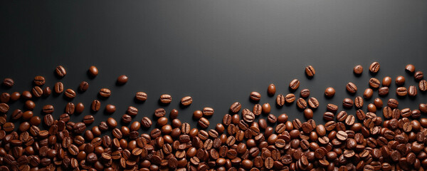Roasted coffee beans are scattered at the bottom of a dark background, with mottled light spots above, creating a stylish and simple banner background, suitable for a header or decoration.