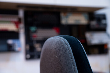A detailed view of a modern and organized workspace, showcasing dual monitors displaying dynamic blue visuals, complemented by indoor plants and a collection of mechanical keyboards.