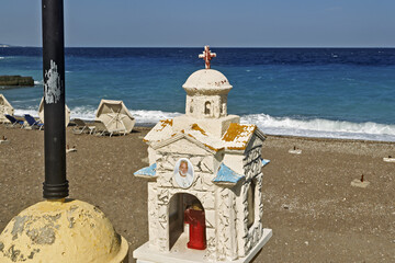 Iconostasis on the beach commemorating a victim of an accident at Paralia Elli beach in Rhodes,...