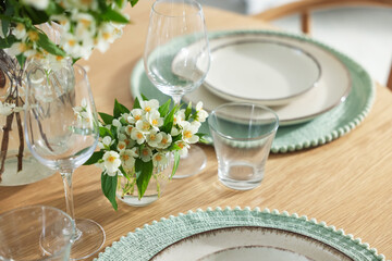 Beautiful jasmine flowers on dining table indoors, closeup