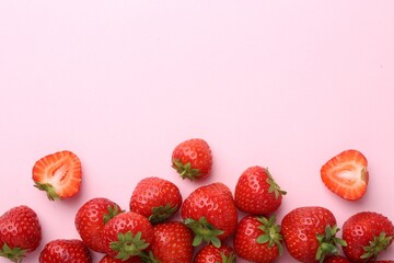 Fresh ripe strawberries on light pink background, flat lay. Space for text