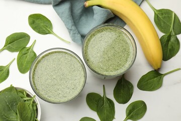 Tasty spinach smoothie and ingredients on white table, flat lay