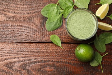 Tasty spinach smoothie and ingredients on wooden table, flat lay. Space for text