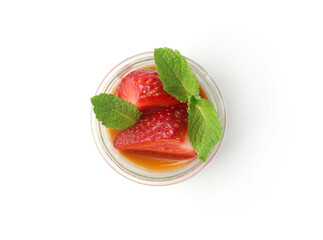 Tasty panna cotta with caramel, strawberries and mint in glass jar isolated on white, top view
