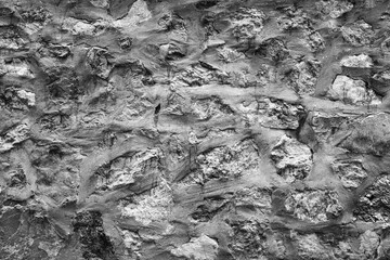 Empty black and white (light gray) embossed cement grunge wall for abstract background and texture for interior or exterior design. Beautiful patterns, space for work, banner, wallpaper close up.