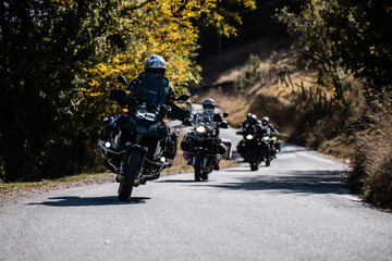 Bikers riding on country road in autumn