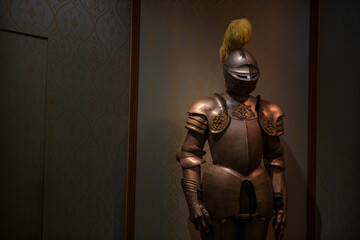 Armor and helmet medieval knight suit in dark castle room