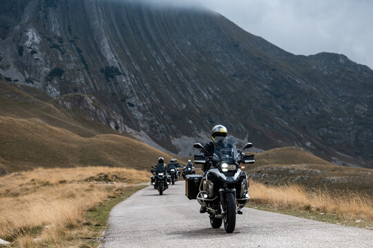 Bikers riding on scenic mountain road in autumn