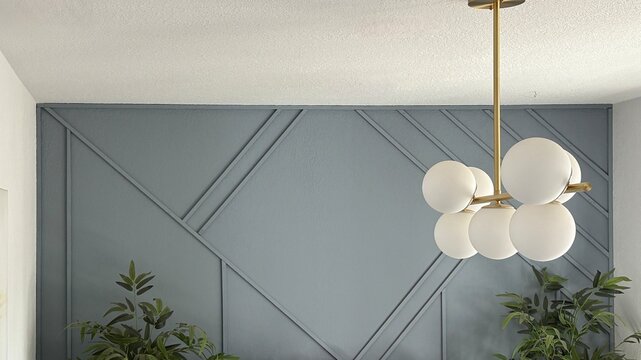 modern dining room blue accent wall with frosted globe chandelier light