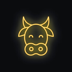 Neon cow sign glowing on a black background