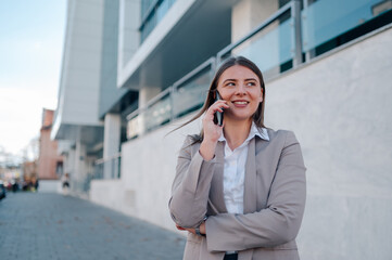 Businesswoman using smartphone near office building