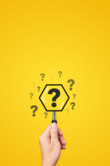 Hand Holding Magnifying Glass with Question mark inside the lens emphasizes - Concept of Problem...