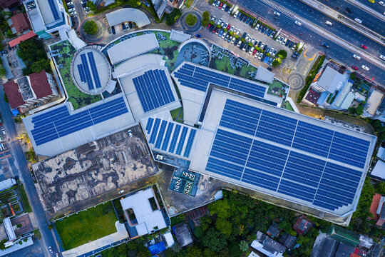Solar roof, Solar on the roof, top view worker installing a solar cell on the factory roof, panels on tin roof seen from aerial view, panesl power.	
