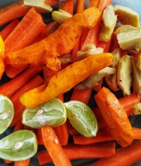 Container with carrots, lime, turmeric. Raw food concept, vegan, vegetarian, healthy juices