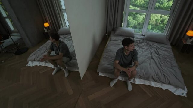 Mentally unstable man in modern room experiencing psychotic episode, erratic behavior and paranoid manic disorder.