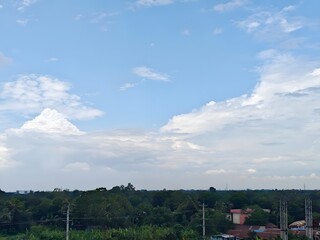 Timelapse clouds drifting over the city skyline and natural landscape