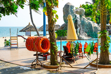 Tropical Resort Poolside with Life Jackets and Lifebuoys by the Beach, Safety by the Sea