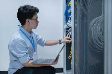 Computer engineer is setting up network in server room,Systems Maintenance Technician,Male engineer...