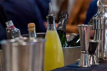Bottle of lemonade ready to use in cocktails on a bar counter