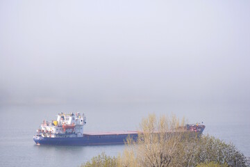 View of the Don river in the fog. The barge floats on the river.