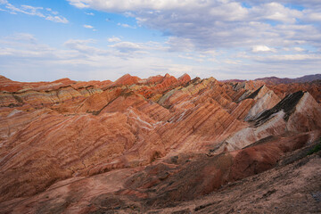 Amazing scenery of Rainbow mountain and blue sky background in sunset. Zhangye Danxia National Geopark, Gansu, China. Colorful landscape, rainbow hills, unusual colored rocks, sandstone erosion