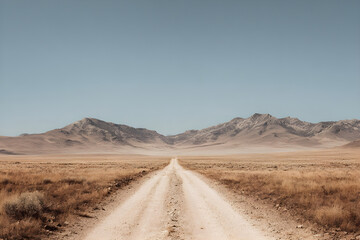 Desert road leading to mountains under a clear sky