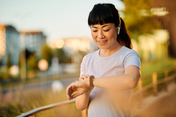 Portrait of a young beautiful sport woman smiling happy and confident. Standing and  doing exercise...
