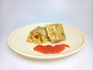Crispy Fried Tofu with Filling Served with Chili Sauce on Plate, Indonesian Street Food Snack Isolated on White Background