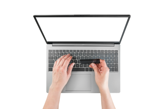 Female hands typing text or working on laptop and holds black credit cardwith empty screen isolated on white background with clipping path. Top view. Design element