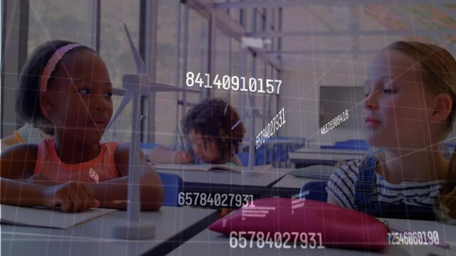 Girl in pink top spinning wind turbine blade in classroom viewing holographic data for learning