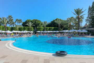 view of swimming pool with people swimming in resort hotel
