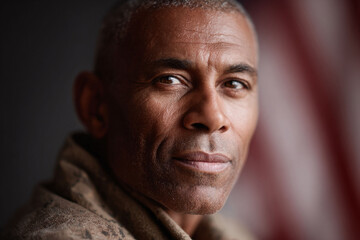 Intimate portrait of a mature AfricanAmerican man, with a confident gaze. Evokes themes of strength, experience, and resilience. Suitable for diverse campaigns  editorial use.