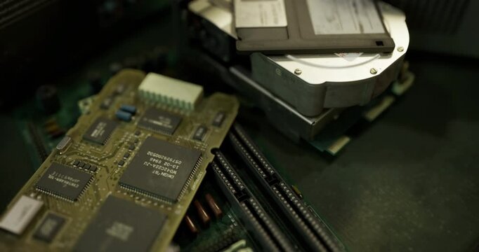 Close up view of vintage computer parts including circuit boards and hard drives. The intricate details reveal technology from earlier computing eras, showcasing unique designs and components.
