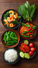 A vibrant arrangement of authentic Thai cuisine is beautifully displayed on a rustic wooden table presenting a delicious and visually appealing meal experience.