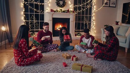 A group of multiracial friends sits on a soft rug in a warmly decorated living room, joyfully exchanging and unwrapping Christmas gifts while surrounded by festive lights and decorations