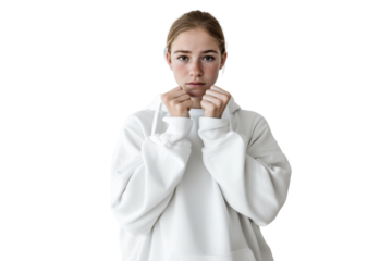 A young girl expressing anxiety and fear, wearing a white hoodie and holding her hands in a defensive posture. Showing stress, shame, and nervousness on a transparent background.