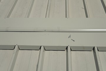 Installation of a specialized ridge cap designed specifically for industrial white sandwich panels....