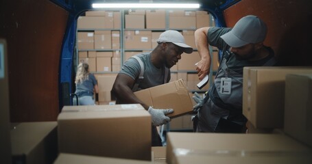Multiethnic Workers Scanning Cardboard Boxes with Online Orders, E-Commerce Goods in Delivery Truck...