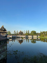 17 January 2024 – Bangkok, Thailand – Traditional Thai-style pavilions and a stone bridge at Ancient City (Muang Boran), a cultural heritage park near Bangkok.