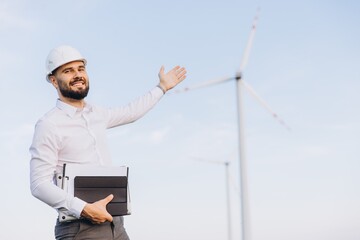 Engineer showing wind turbines in sustainable energy farm