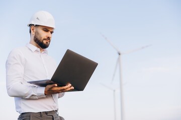 Engineer working with laptop in a wind turbine power plant