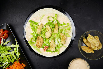 Freshly prepared tortilla wrap filled with grilled chicken, crisp lettuce, and creamy dressing,...
