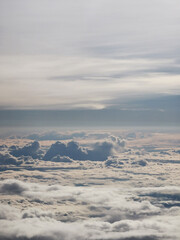 Expansive view of fluffy white clouds layered above a soft blanket of misty clouds, creating a serene atmosphere in the vast sky, perfect for tranquil imagery and relaxation themes