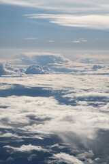 Expansive view of fluffy white clouds against a bright blue sky, showcasing the beauty of nature...