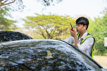 Mechanic or driver providing roadside assistance by changing a flat tire and performing minor...