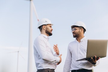 Engineers discussing about a project in a wind turbine power plant