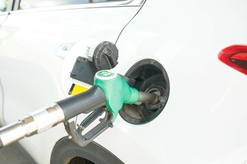 Refueling a White SUV at a Gas Station, ensuring the vehicle is powered for the road ahead