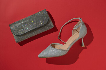 Sparkling High Heel and Clutch on Bold Red Background: Chic Fashion Essentials