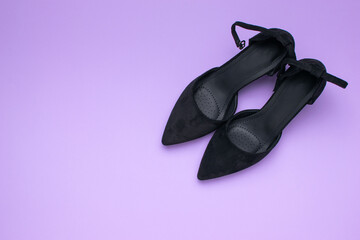 Elegant Black High Heels on Vibrant Purple Background Fashion and Style Concept
